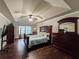 Main bedroom featuring a tray ceiling, ceiling fan and large windows at 4978 Arborview Pkwy, Acworth, GA 30101
