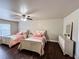 Spacious bedroom with two beds, hardwood floors, a ceiling fan, and a dresser at 4978 Arborview Pkwy, Acworth, GA 30101