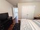 View of a bedroom with a glimpse into the hallway, featuring a double-door closet and modern furnishings at 4978 Arborview Pkwy, Acworth, GA 30101