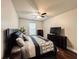 Cozy bedroom with a ceiling fan, dresser, and a window providing natural light at 4978 Arborview Pkwy, Acworth, GA 30101