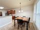 Cozy dining area featuring a wooden table, black chairs, and a charming light fixture at 4978 Arborview Pkwy, Acworth, GA 30101