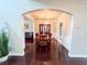 The dining room has wood floors, an elegant chandelier, and views of the living room and kitchen at 4978 Arborview Pkwy, Acworth, GA 30101