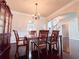 Dining room featuring hardwood floors, a wooden table and chairs, and a chandelier at 4978 Arborview Pkwy, Acworth, GA 30101