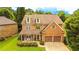 Charming home featuring a brick and stone facade, complemented by a well-manicured lawn and a two-car garage at 4978 Arborview Pkwy, Acworth, GA 30101