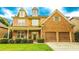 Charming two-story home featuring a blend of brick and stone, a cozy front porch, and an attached two-car garage at 4978 Arborview Pkwy, Acworth, GA 30101