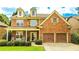 Inviting two-story home with a brick and stone exterior, a welcoming front porch, and a convenient two-car garage at 4978 Arborview Pkwy, Acworth, GA 30101