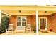 Inviting front porch with rocking chairs, a bench, and beautiful plants on the entrance at 4978 Arborview Pkwy, Acworth, GA 30101