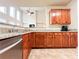 Well-lit kitchen featuring stone counters, stainless dishwasher, and wooden cabinets at 4978 Arborview Pkwy, Acworth, GA 30101