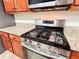 Close-up of the kitchen range, featuring granite countertops and wood cabinets at 4978 Arborview Pkwy, Acworth, GA 30101