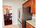 Modern kitchen featuring stainless steel refrigerator and warm wood cabinetry at 4978 Arborview Pkwy, Acworth, GA 30101