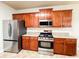 Modern kitchen with stainless steel appliances, granite countertops, and wooden cabinets at 4978 Arborview Pkwy, Acworth, GA 30101