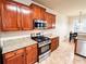 Kitchen with wood cabinets, stainless steel appliances, granite countertops, and tile floors at 4978 Arborview Pkwy, Acworth, GA 30101
