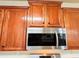 Close-up of the kitchen microwave, featuring wood cabinets and stainless steel at 4978 Arborview Pkwy, Acworth, GA 30101