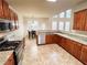 Open kitchen with granite countertops, stainless steel appliances, and wooden cabinets at 4978 Arborview Pkwy, Acworth, GA 30101