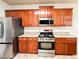 Modern kitchen with stainless steel appliances, granite countertops, and wooden cabinets at 4978 Arborview Pkwy, Acworth, GA 30101