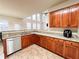 Open kitchen with stone counters, stainless dishwasher, and wooden cabinets at 4978 Arborview Pkwy, Acworth, GA 30101