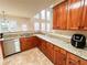 Light-filled kitchen with stone counters, stainless dishwasher, and wooden cabinets at 4978 Arborview Pkwy, Acworth, GA 30101