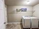 Neat laundry room features tile flooring, washer, dryer, and storage shelf at 4978 Arborview Pkwy, Acworth, GA 30101