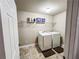 Clean laundry room with washer, dryer, shelving, and tile floor at 4978 Arborview Pkwy, Acworth, GA 30101