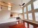Open concept living room and dining room with tall windows and a ceiling fan for ample natural light and air flow at 4978 Arborview Pkwy, Acworth, GA 30101
