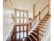 Open staircase that views the living room that has a fireplace, ceiling fan, and large windows at 4978 Arborview Pkwy, Acworth, GA 30101