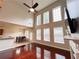 Open concept living room and dining room with tall windows and a ceiling fan for ample natural light and air flow at 4978 Arborview Pkwy, Acworth, GA 30101
