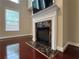 Cozy living room with a classic fireplace and large windows allowing natural light at 4978 Arborview Pkwy, Acworth, GA 30101