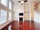 Living room with tall windows, high ceilings, hardwood floors, ceiling fan, and a fireplace at 4978 Arborview Pkwy, Acworth, GA 30101