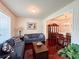 Cozy living room with hardwood floors, comfortable seating, and view to dining area at 4978 Arborview Pkwy, Acworth, GA 30101
