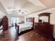 Spacious main bedroom featuring tray ceiling, sitting area, and dark wood furniture at 4978 Arborview Pkwy, Acworth, GA 30101