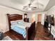 This main bedroom features a tray ceiling, dark furniture, and an adjacent bathroom at 4978 Arborview Pkwy, Acworth, GA 30101