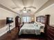 Comfortable main bedroom featuring tray ceiling, fan, dresser, and relaxing recliner at 4978 Arborview Pkwy, Acworth, GA 30101