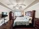 Main bedroom featuring a tray ceiling, furniture, and wooden floors at 4978 Arborview Pkwy, Acworth, GA 30101