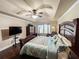 Well-lit main bedroom boasts a tray ceiling, fan, dark furniture, and ample space at 4978 Arborview Pkwy, Acworth, GA 30101
