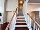 Staircase with dark hardwood stairs and white risers, leading to the upper level at 4978 Arborview Pkwy, Acworth, GA 30101