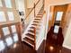 Elegant staircase featuring hardwood steps, white risers, and natural light at 4978 Arborview Pkwy, Acworth, GA 30101