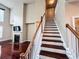 Staircase with dark hardwood steps leading to the living area with a fireplace at 4978 Arborview Pkwy, Acworth, GA 30101