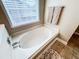 Bathroom featuring a soaking tub and decorative towels at 4978 Arborview Pkwy, Acworth, GA 30101