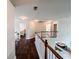 Upstairs hallway with wood floors, railing, and view to dining area below at 4978 Arborview Pkwy, Acworth, GA 30101