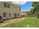 Fenced backyard features a patio with seating area, and a grassy lawn at 560 Vandenburg Dr, Villa Rica, GA 30180