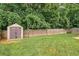 Backyard with shed, grassy area, and a wooden fence at 560 Vandenburg Dr, Villa Rica, GA 30180