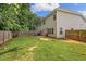 Backyard features a grassy lawn and a wooden fence at 560 Vandenburg Dr, Villa Rica, GA 30180