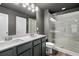 Modern bathroom with double sink vanity and a glass enclosed shower at 560 Vandenburg Dr, Villa Rica, GA 30180