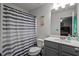 Clean bathroom with shower curtain and single sink vanity at 560 Vandenburg Dr, Villa Rica, GA 30180