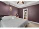 Comfortable bedroom featuring a ceiling fan, tray ceilings, and ensuite bathroom at 560 Vandenburg Dr, Villa Rica, GA 30180