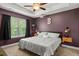 Comfortable bedroom featuring a ceiling fan, tray ceilings, and decor at 560 Vandenburg Dr, Villa Rica, GA 30180