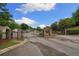 Gated community entrance with brick pillars and wrought iron gates, surrounded by mature trees at 560 Vandenburg Dr, Villa Rica, GA 30180