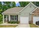 Charming single-story home with a well-maintained front yard, covered porch, and attached one car garage at 560 Vandenburg Dr, Villa Rica, GA 30180