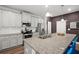 Bright kitchen featuring granite counters, white cabinets, and stainless steel appliances at 560 Vandenburg Dr, Villa Rica, GA 30180
