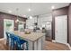 Well-lit kitchen with a large island, bar stool seating, and stainless steel appliances at 560 Vandenburg Dr, Villa Rica, GA 30180